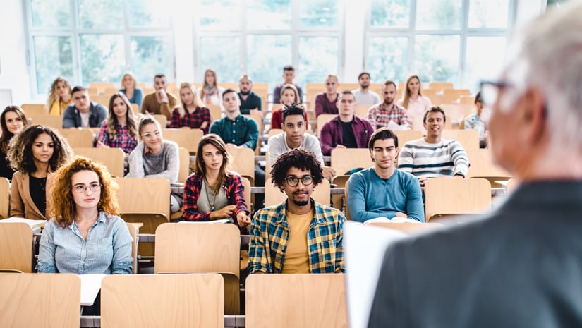 Large Group of College Students Listening to Their Professor