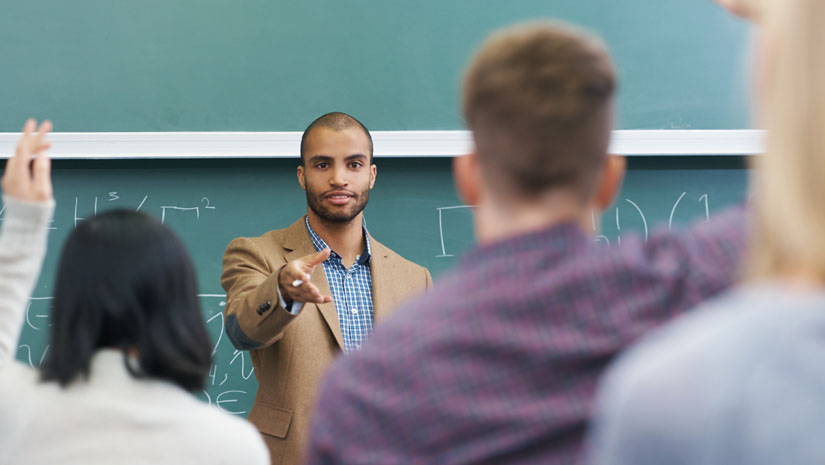 Shot of a young male teacher giving a lesson to his students on the lecture hall