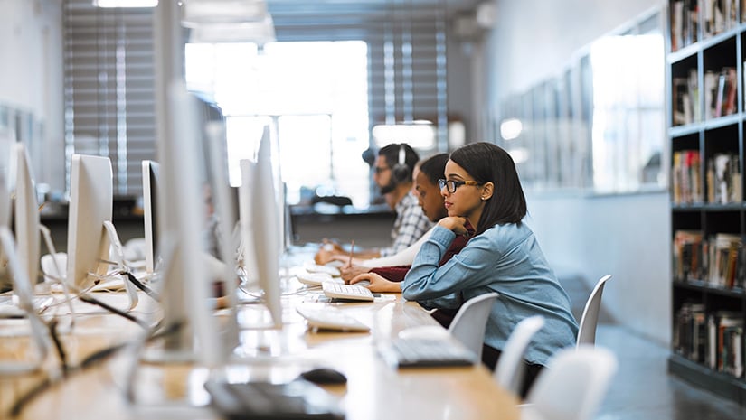 Shot of a group of university students working on computers in the library