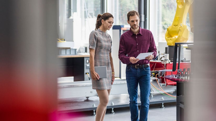 Manufacturing workers walking through hallway