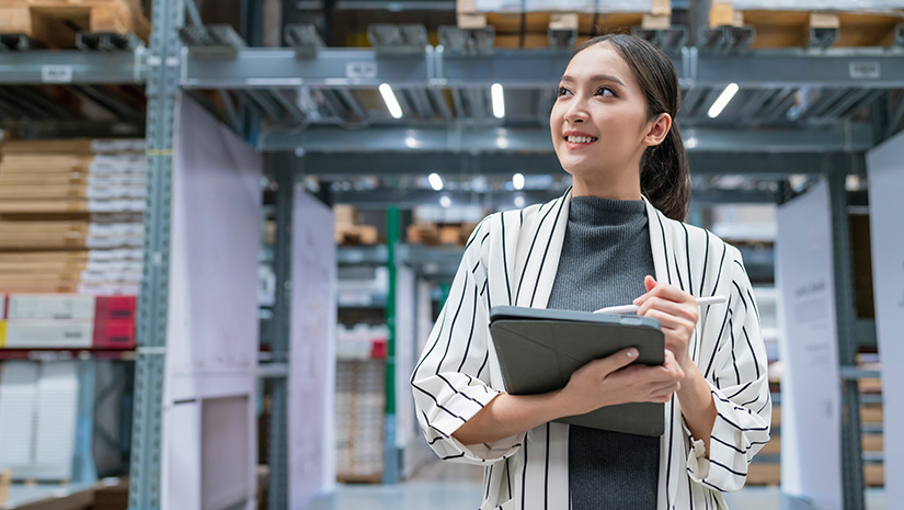 Woman business owner using digital tablet checking amount of stock