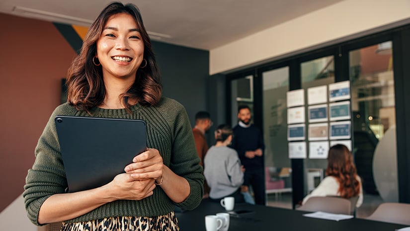 Cheerful businesswoman smiling at the camera in a boardroom