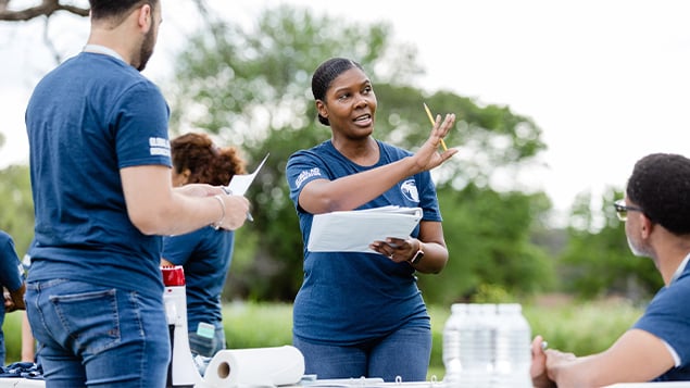 Female team leader gestures while explaining where things should be set up