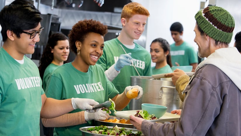 Nonprofit volunteers serving food in a food kitchen