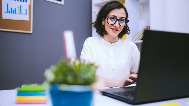 Woman In Eyeglasses Typing Report