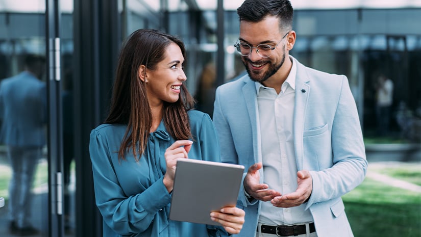 Business people using digital tablet outdoors