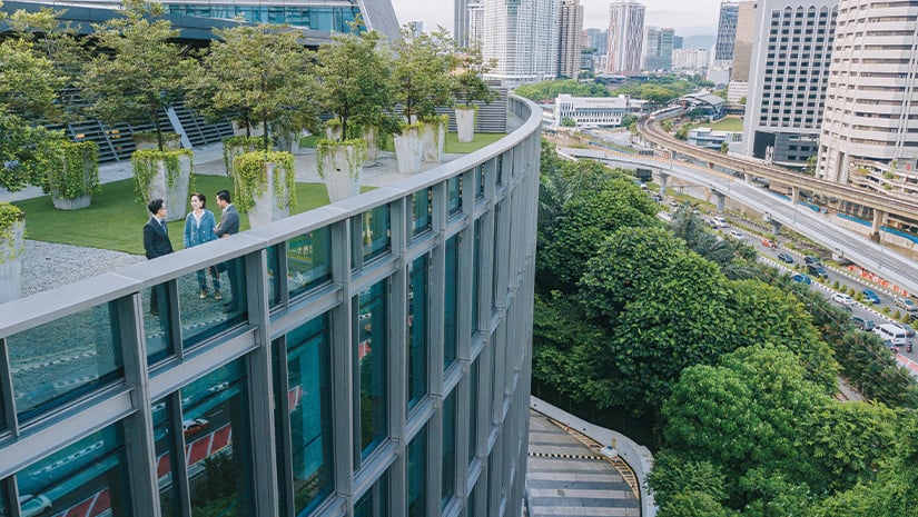 Business person talking on roof top garden outside office building