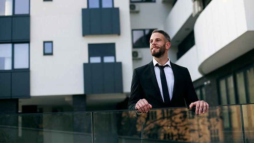 Businessman in front of his building