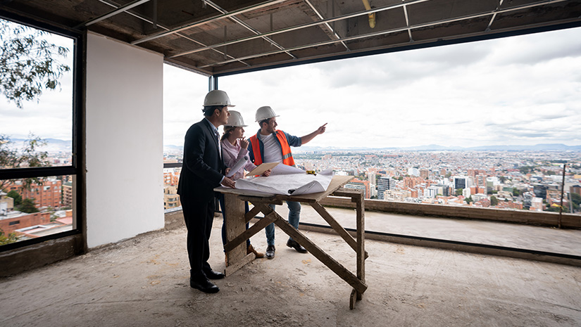 Contractor architect and engineer working as a team at a construction site