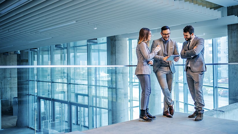 Group of successful real estate agents standing in building