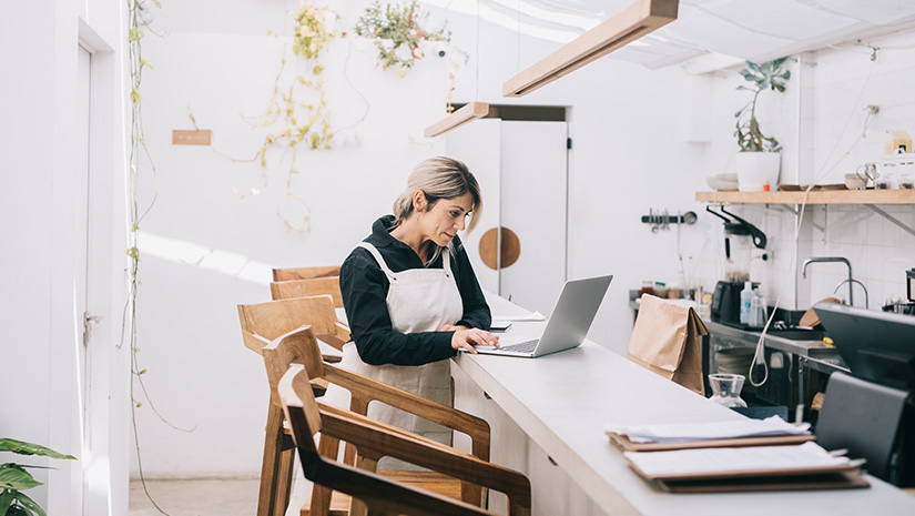 Cafe Manager Working Behind the Counter
