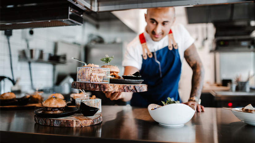 Cook serving food at restaurant