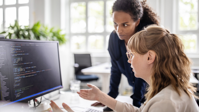Colleagues Reviewing Code Together