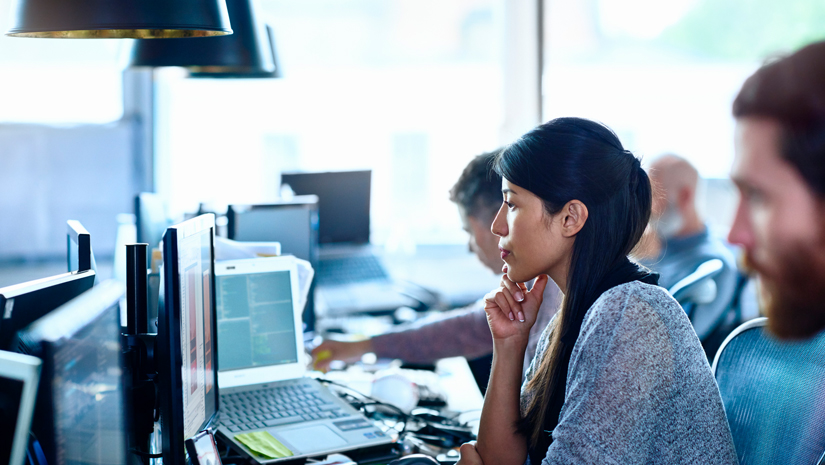 Shot of tech support answering calls and reviewing computers in IT lab