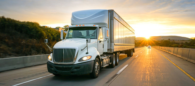 American truck on the road at sunset