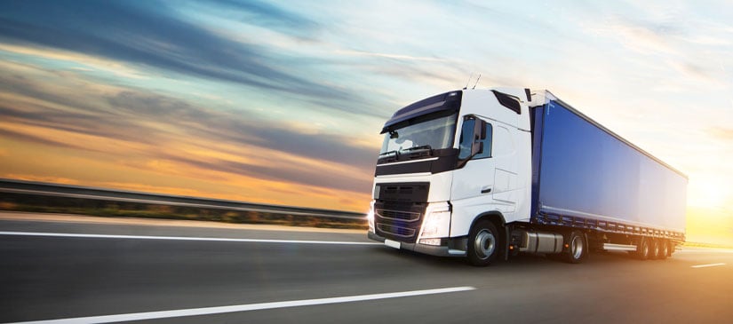 Loaded European truck on motorway in beautiful sunset light.