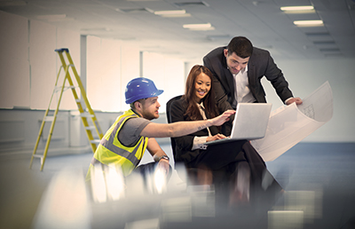Contractor with Consultants Reviewing Laptop