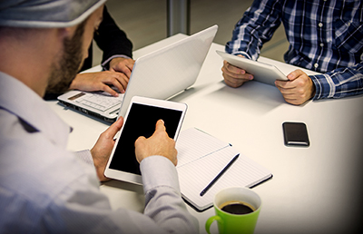 Three Meeting Mobile Devices Laptop