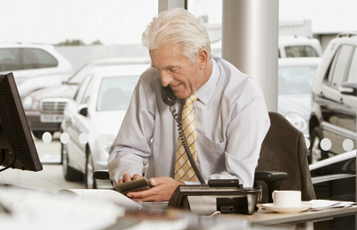 Dealership Owner Using a Calculator