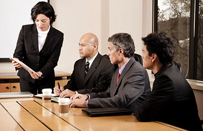 Businesswoman Presenting in Boardroom
