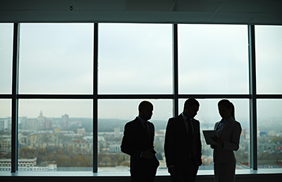 Group Standing by Window Backlit