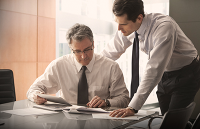 Two-Businessmen-Conference-Room-Documents