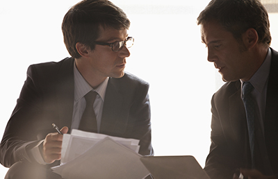 Two Businessmen Discussion Holding Documents