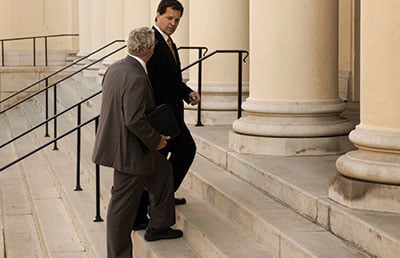 Two Men Walking- Up Courthouse Steps