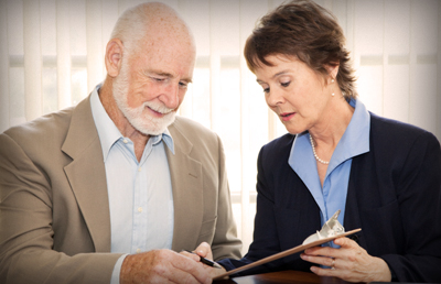 Two People Reviewing Signing Document