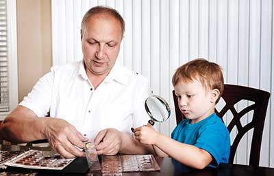 Grandfather Grandson Sharing Coin Collection