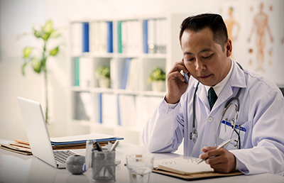 Doctor-On-Mobile-Phone-Taking-Notes.jpg