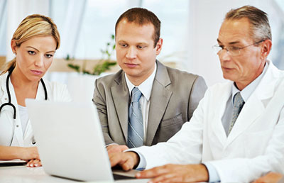 Doctors and Consultant Looking Serious at Computer