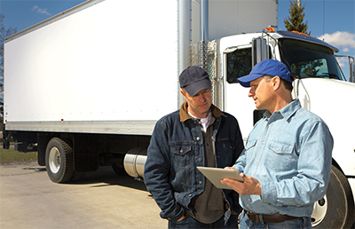 Two Truckers Looking at Tablet