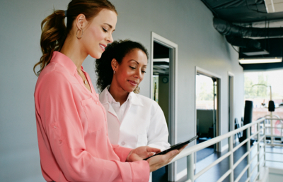 Two business women reviewing tablet